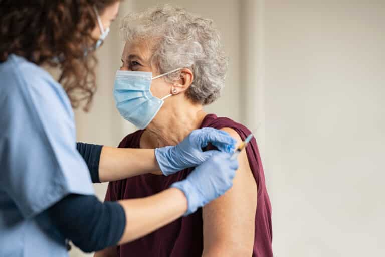 senior woman getting Covid vaccine