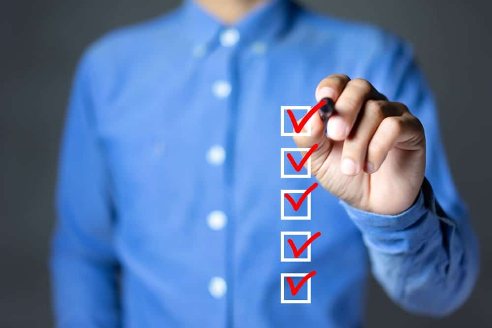 man checkmarking boxes