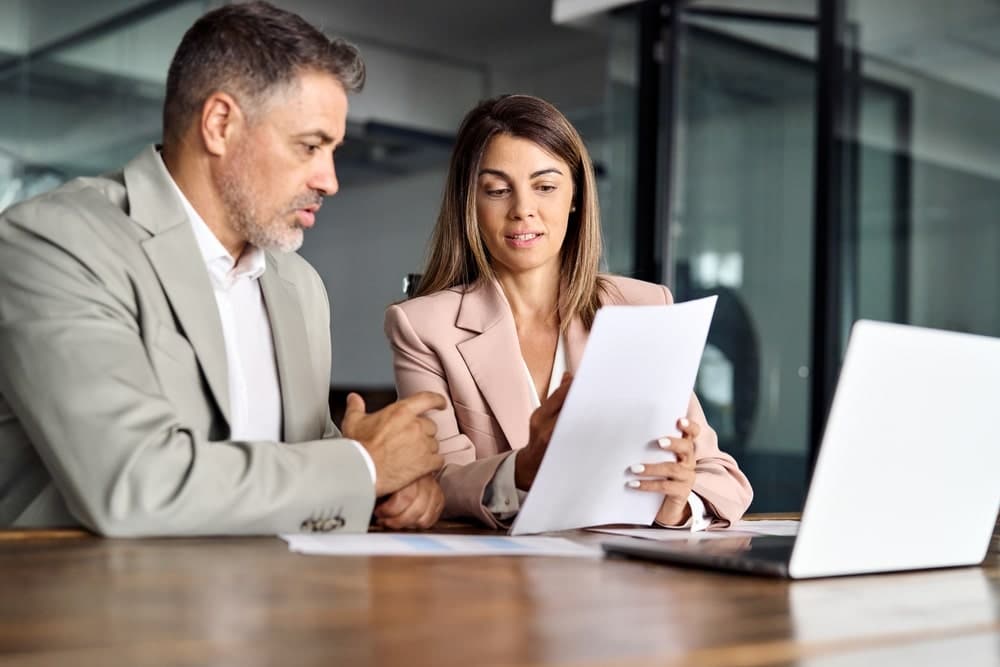 business man and woman going over papers
